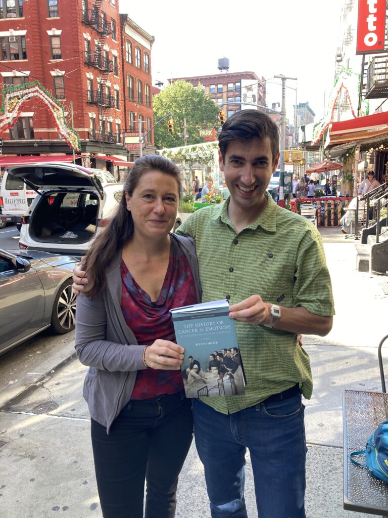 Photo of Bettina Hitzer and Adam Bresnahan holding copy of book